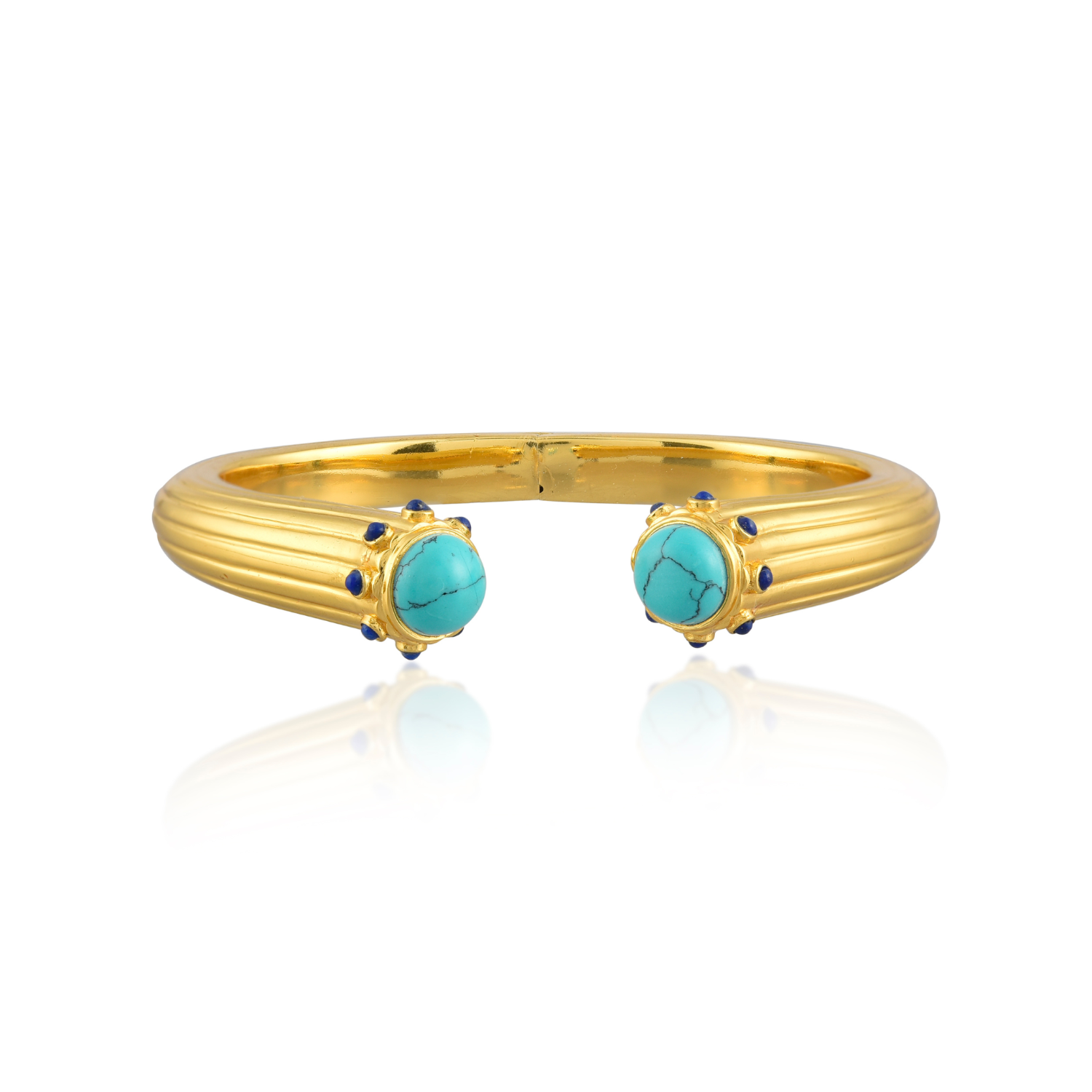 Gold bangle with turquoise stones on a white background