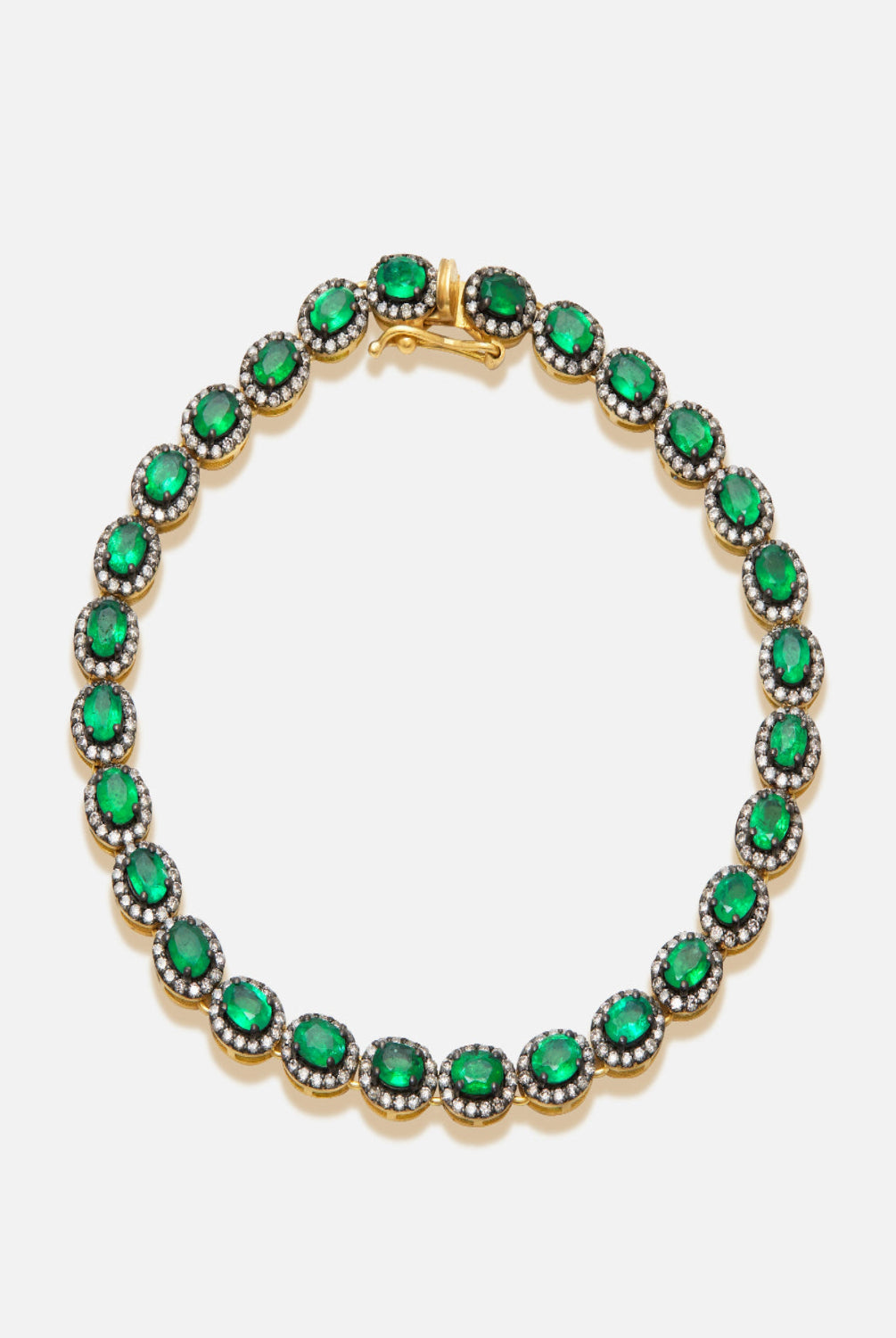 Bracelet with green gemstones on a white background