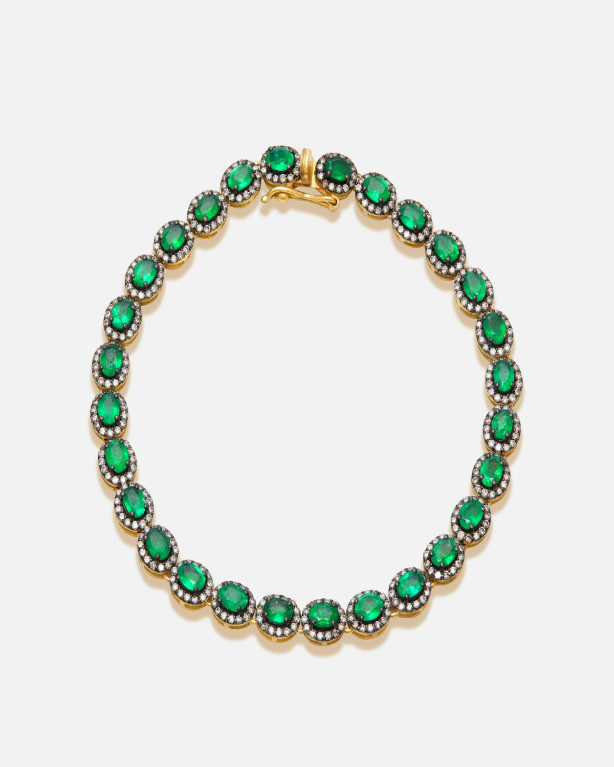 Bracelet with green gemstones on a white background