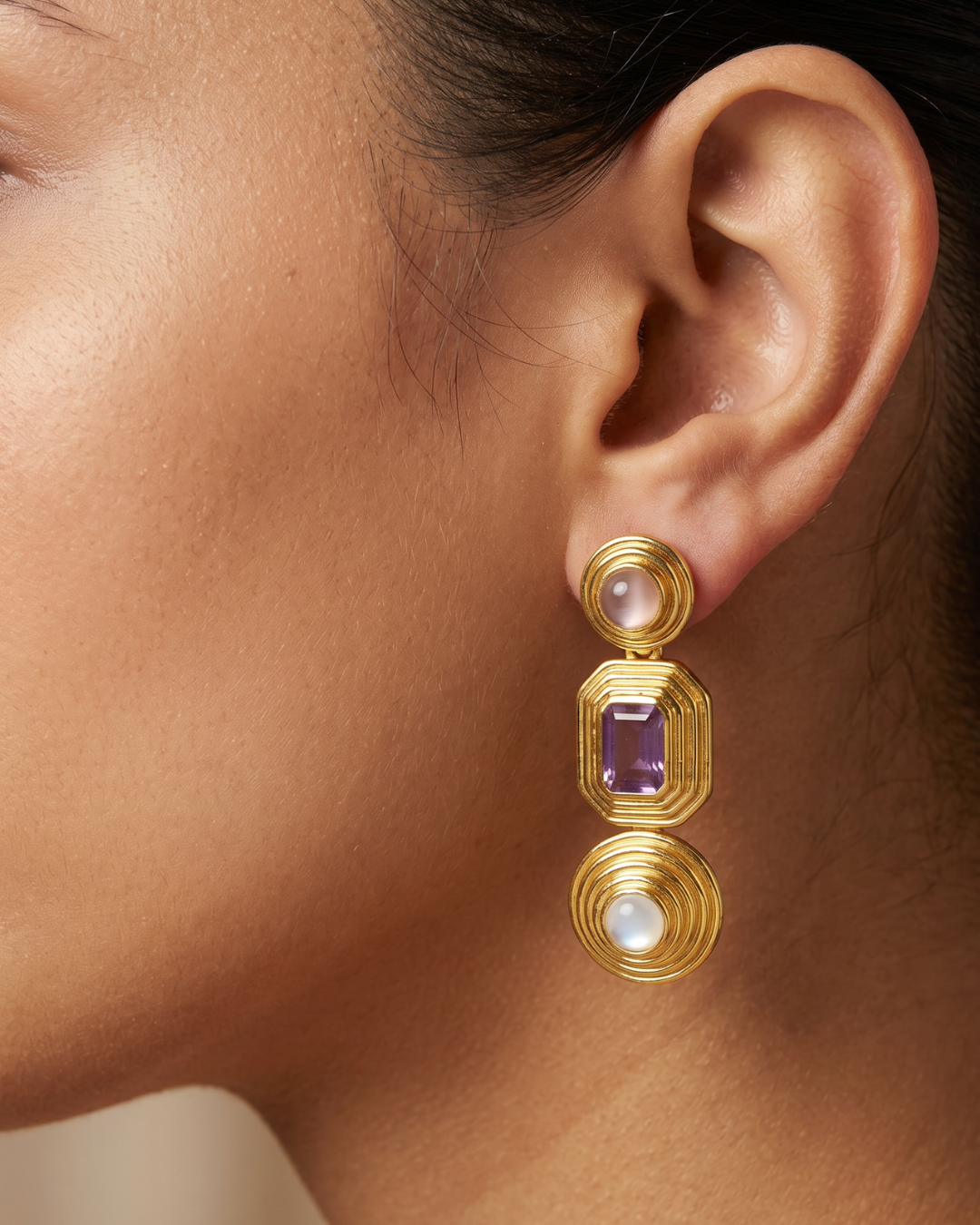 AI Image : Gold earrings with purple and white gemstones worn by a person