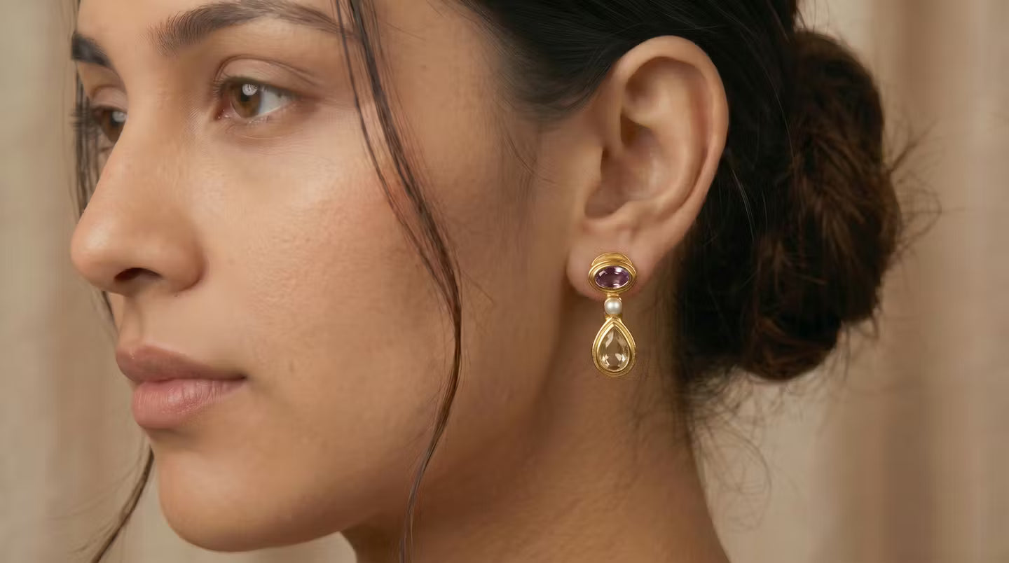 AI Image: Close-up of a woman wearing gold drop earrings with pearl, purple and yellow stones on a beige background
