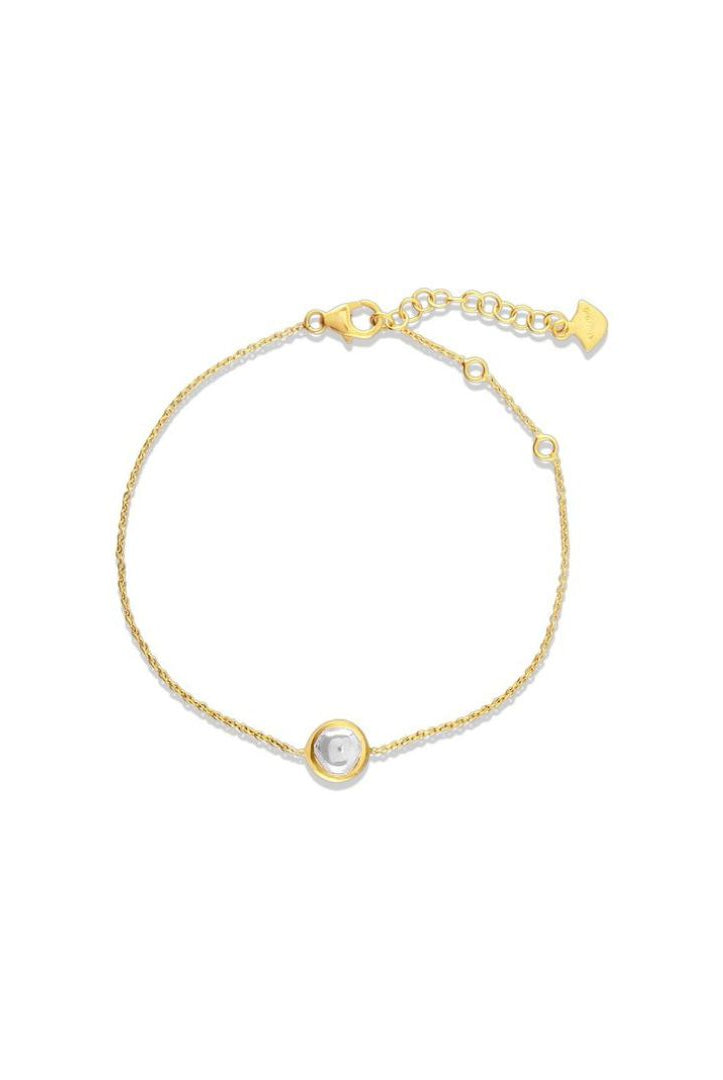 Gold bracelet with a small round gemstone on a white background