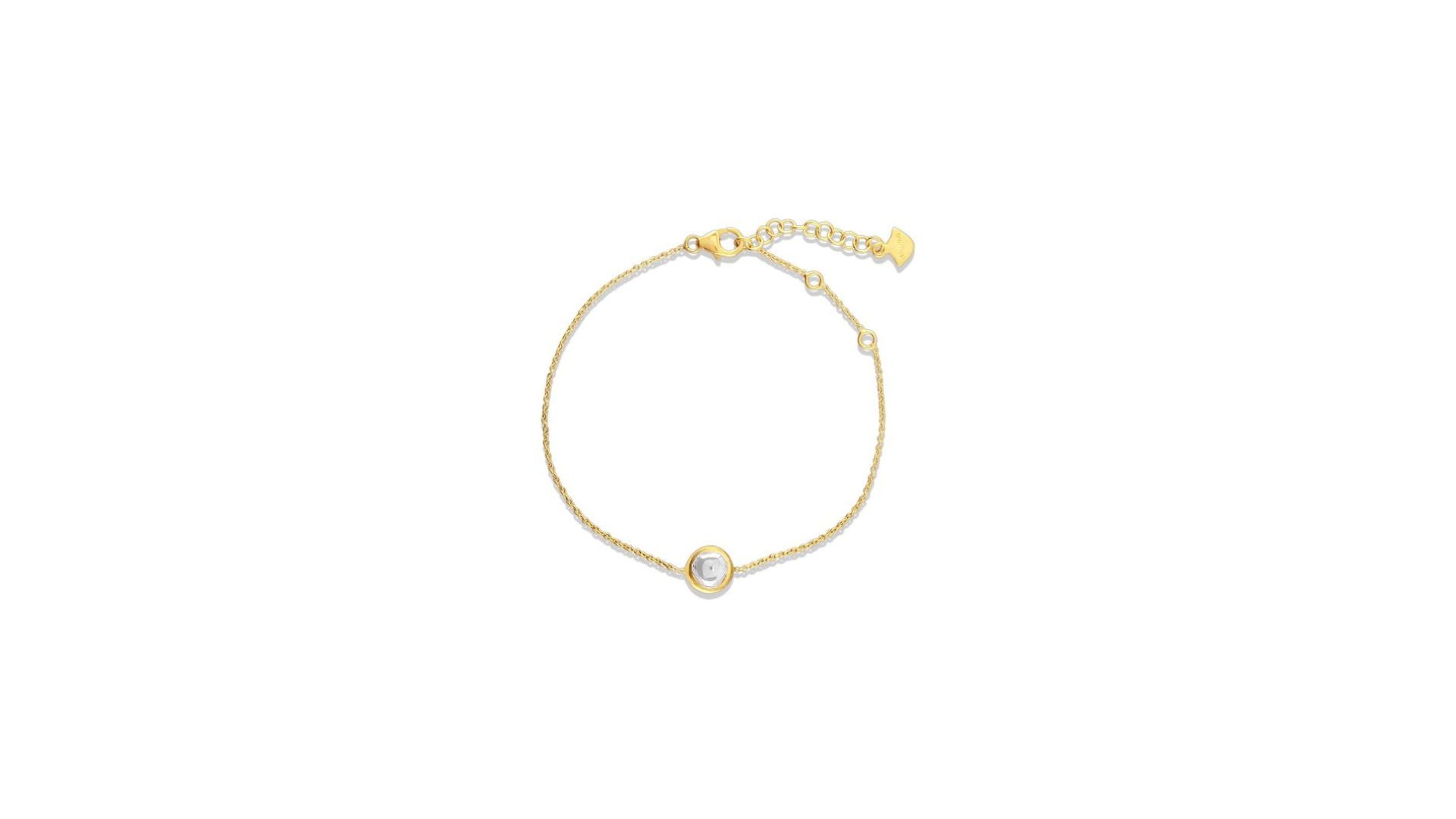 Gold bracelet with a small round gemstone on a white background