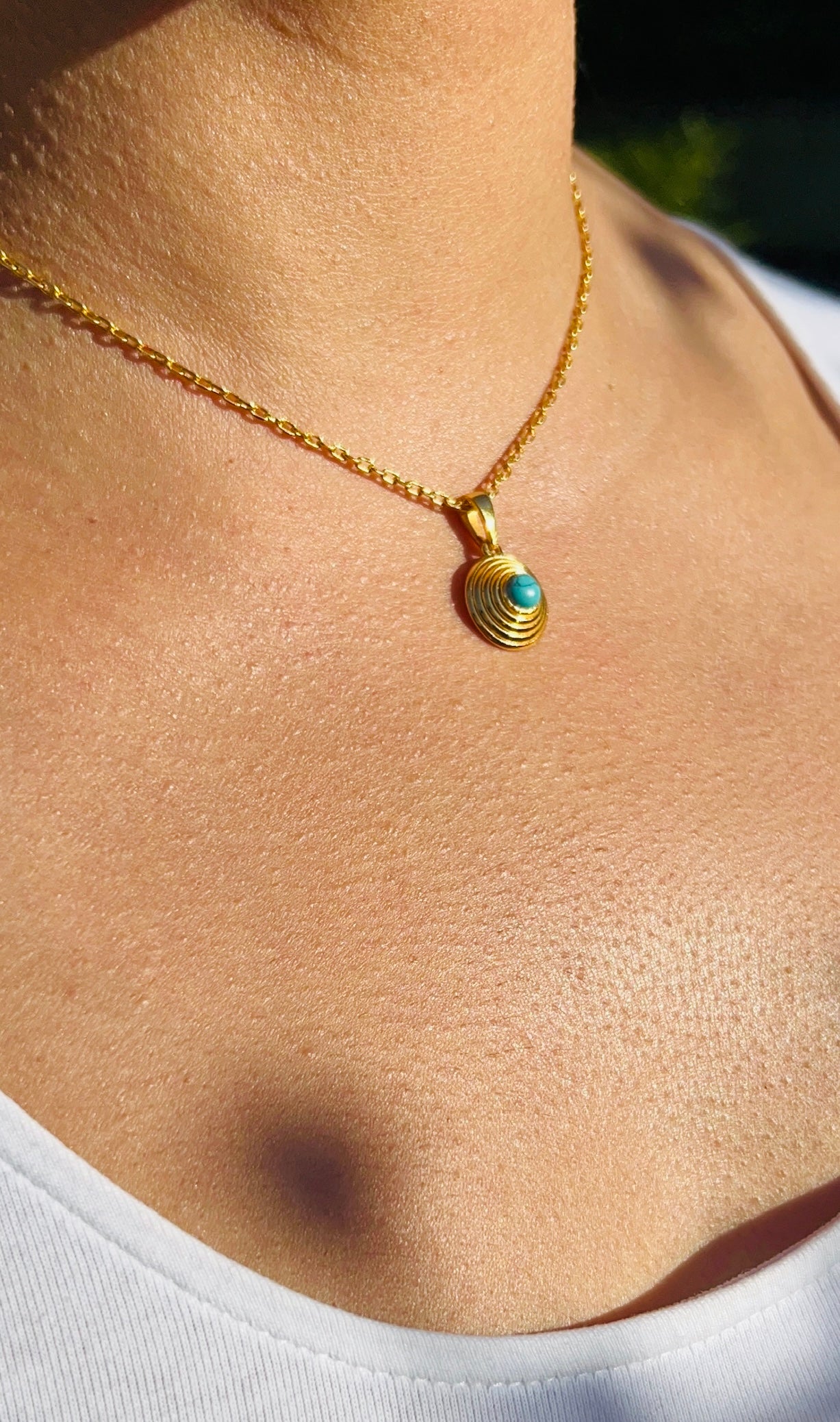 model wearing gold plated and turquoise pendant necklace