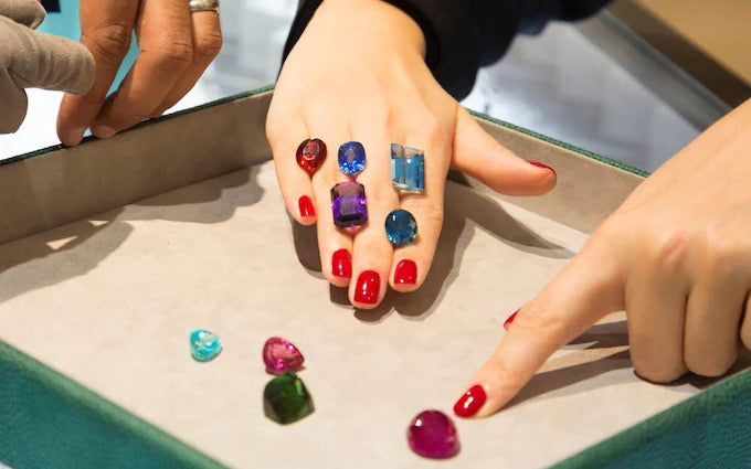 Coloured loose jewels being selected at Amrapali's Gem Bar