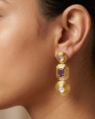 AI Image : Gold earrings with purple and white gemstones worn by a person