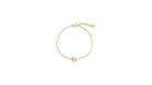 Gold bracelet with a small round gemstone on a white background